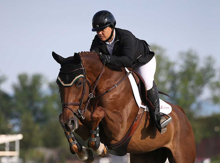 Tracy Magness jumping fences on horse
